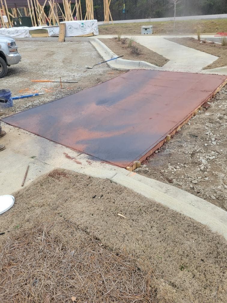 Fresh concrete poured and leveled in prepared forms at a residential job site - JSW Construction