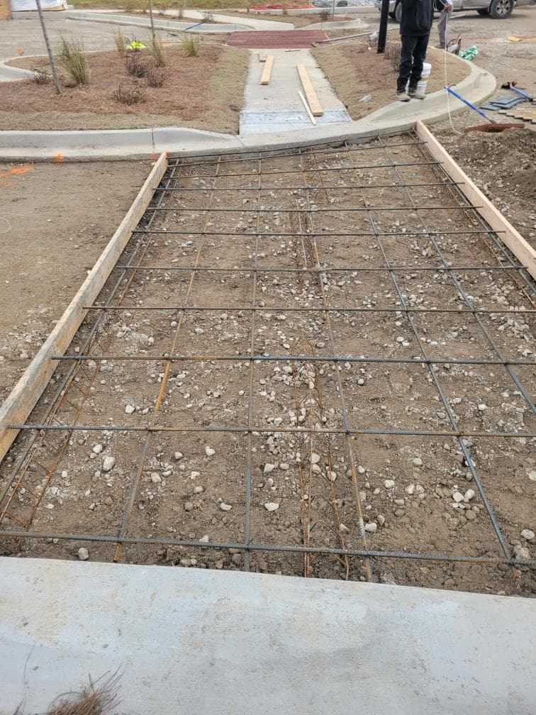 Steel rebar reinforcement laid in forms ready for concrete pour - JSW Construction