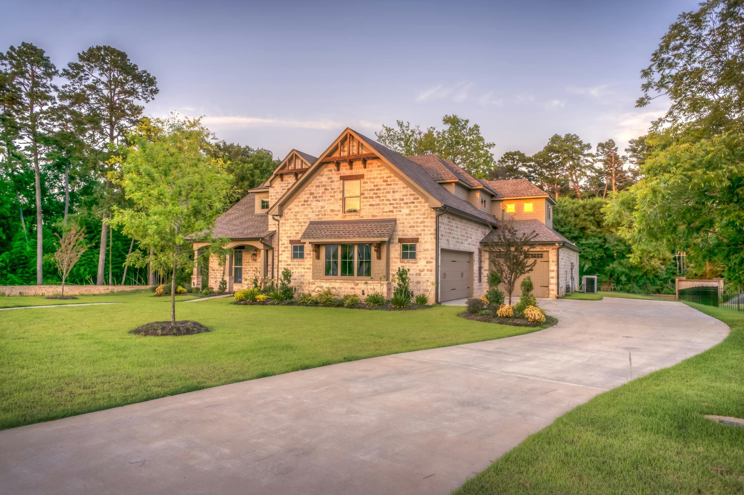 Beautiful craftsman home with wide concrete driveway at golden hour - JSW Construction driveway widening